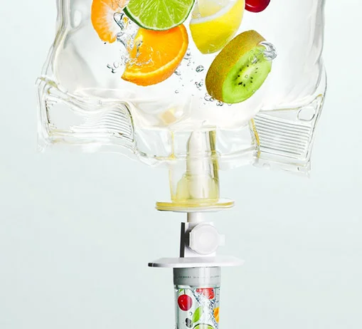 Hair health vitamin drip surrounded by avocados, nuts and a hairbrush